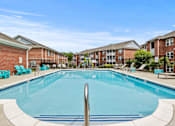 Thumbnail 13 of 34 - A swimming pool in front of apartment buildings.