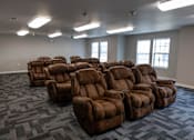 Thumbnail 32 of 41 - A room full of brown recliner chairs.