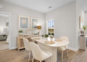 Thumbnail 53 of 83 - A dining room with a white table and chairs.