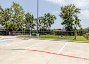 Thumbnail 30 of 39 - A parking lot with a blue handicap sign painted on the pavement.