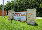 Thumbnail 28 of 39 - A sign for ERDOVA APARTMENTS stands in front of a stone pillar.