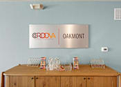 Thumbnail 9 of 39 - A wooden table with a metal sign that says Oakmont above it.