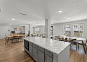 Thumbnail 11 of 39 - A kitchen with a large island and dining area.