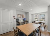 Thumbnail 1 of 39 - A dining room with a wooden table and chairs.