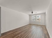 Thumbnail 16 of 39 - A room with wooden flooring and a ceiling fan.