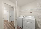 Thumbnail 22 of 39 - A laundry room with a washer and dryer.