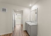 Thumbnail 15 of 39 - A bathroom with a sink and mirror.