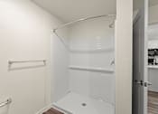 Thumbnail 18 of 39 - A white bathroom with a walk-in shower.