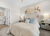 Thumbnail 47 of 83 - A bedroom with a large bed and a ceiling fan.
