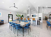 Thumbnail 52 of 83 - A spacious room with a long table surrounded by chairs.