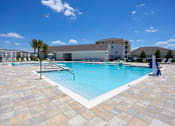Thumbnail 57 of 83 - A large swimming pool surrounded by a tiled patio.