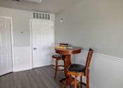 Thumbnail 5 of 41 - A small table with a chair in a room.