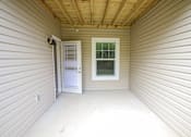 Thumbnail 10 of 25 - A small room with a door and a window.