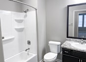 Thumbnail 29 of 31 - Bathroom with shower, toilet, and sink at Promenade Luxury apartments in Beaumont, Texas