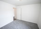Thumbnail 12 of 17 - Bedroom with white walls and carpet at Canterbury House Newburgh Apartments in Newburgh, IN