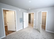 Thumbnail 17 of 25 - A room with four doors, one of which is open.