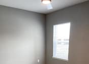 Thumbnail 28 of 31 - Empty bedroom with carpeting at Promenade Luxury apartments in Beaumont, Texas