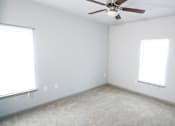 Thumbnail 25 of 31 - Empty bedroom with a ceiling fan and two windows at Mosaic Apartments in Avon, Indiana