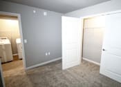 Thumbnail 12 of 25 - A room with a white door and a white wall with a light switch.