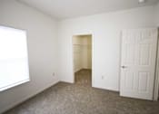 Thumbnail 25 of 28 - A room with a carpeted floor and a white door.
