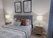 Thumbnail 18 of 22 - A bed with night stand and lamp at The Lofts at Canterbury in Slidell, Louisiana
