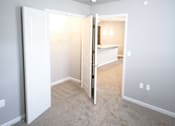 Thumbnail 16 of 25 - A room with a carpeted floor and white walls.