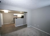 Thumbnail 13 of 17 - Empty living room with a kitchen in the background a tCanterbury House apartments in Tipton, Indiana