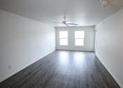 Thumbnail 10 of 17 - Empty living room with white walls and a ceiling fan at Canterbury House Newburgh Apartments in Newburgh, IN