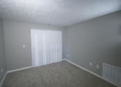 Thumbnail 14 of 17 - Empty living room with a large window and white blinds at Canterbury House apartments in Tipton, Indiana