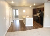 Thumbnail 21 of 25 - A spacious living room with a white ceiling fan and a white kitchen island.