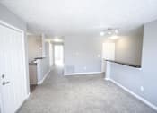 Thumbnail 22 of 25 - An empty living room with carpet at Cobalt Apartments in Kokomo, Indiana