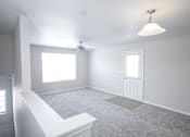Thumbnail 21 of 43 - A white room with a ceiling fan and a window.