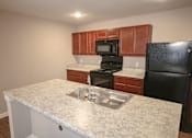 Thumbnail 2 of 9 - Kitchen with sink and stove at Meadows on Main in Whitestown, Indiana