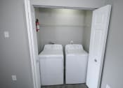Thumbnail 6 of 11 - White washer and dryer in a room at Canterbury House apartments in Logansport, Indiana
