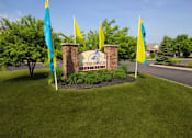 Thumbnail 1 of 15 - a sign in the grass for Canterbury Apartments in Kalamazoo, MI