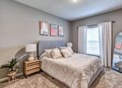 Thumbnail 25 of 34 - Bedroom with a large bed and a large window at Flats at Sundown apartments in North Port, Fl
