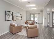Thumbnail 2 of 21 - A spacious living room with a grey floor and white walls.