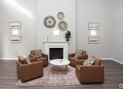Thumbnail 1 of 21 - A living room with a fireplace and brown couches.