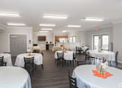 Thumbnail 6 of 21 - A dining room with tables set for a meal.