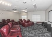 Thumbnail 10 of 21 - A room with red leather chairs and a grey carpet.