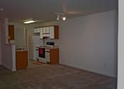 Thumbnail 6 of 6 - A kitchen with white appliances and wooden cabinets.
