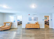 Thumbnail 29 of 35 - A room with a couch, a bed, and a sign that says "SANDPIPER".