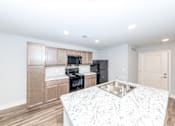 Thumbnail 4 of 35 - A kitchen with a sink and cabinets.
