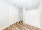 Thumbnail 16 of 35 - A white door is on the left and a white bathtub is on the right.