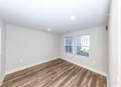 Thumbnail 11 of 35 - A room with wooden flooring and a window.