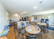 Thumbnail 25 of 35 - A dining room with a wooden table surrounded by chairs.