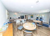 Thumbnail 26 of 35 - A kitchen with a table and chairs in the middle of the room.