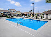 Thumbnail 11 of 19 - A large swimming pool with a blue tinted water.