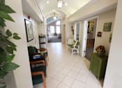Thumbnail 8 of 15 - a hallway with chairs at canterbury apartments in kalamazoo, mi