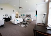 Thumbnail 5 of 15 - Clubhouse living room with couches and a coffee table at Canterbury Apartments in Kalamazoo, Mi